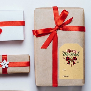 Kraft Christmas gift tag stickers with Merry Christmas greeting and bow detail on a gift box