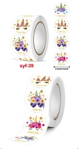 Close-up of 1-inch unicorn Thank You stickers roll with colorful cartoon patterns