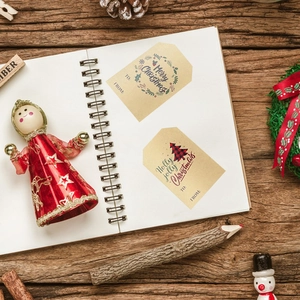 Christmas kraft paper gift tags with festive wreaths and trees on white paper