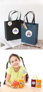Close-up of cute cartoon unicorn and mermaid thank you stickers on gift packaging