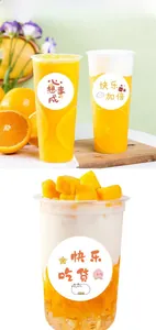 Close-up of clear plastic beverage cups with creative cartoon stickers and fruit decor