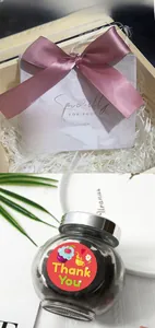 Detail showing cartoon Thank You stickers on gift boxes and glass jars for decoration