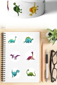 Close-up of cute cartoon dinosaur reward stickers applied to a spiral notebook
