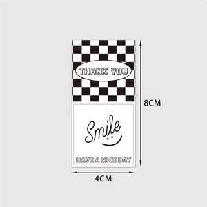 Detail of 8x4cm rectangular black and white checkerboard Smile seal labels for gift packaging
