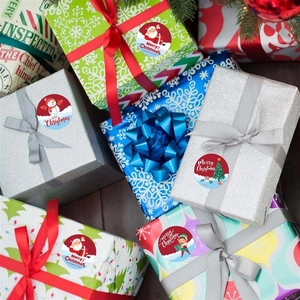 Close-up of Merry Christmas stickers on gift boxes for festive holiday packaging