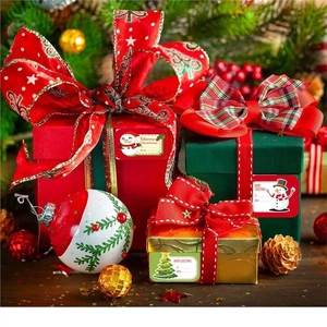 Christmas gift tag stickers featuring festive motifs on colorful holiday present boxes