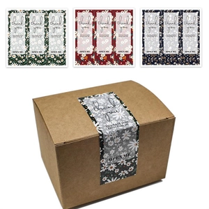 Macro detail of floral Thank You stickers on brown corrugated box for gift packaging