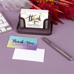 Marble and celestial pattern thank you cards set displayed on office desk with organizer