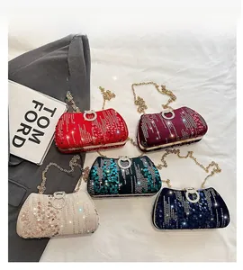 Macro shot of sequined evening bags with gold chains and decorative diamond clasps
