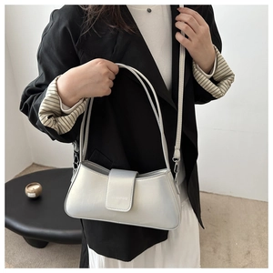 Chic silver metallic baguette bag shown with detachable long shoulder strap and handle