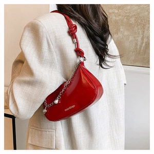 Red glossy hobo bag with silver chain, pearl heart charm and knot shoulder strap detail