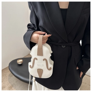 Detail of creative violin-shaped crossbody bag with vintage faux leather texture