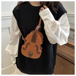 Detail of creative violin-shaped crossbody bag featuring brown leather and metal rivets