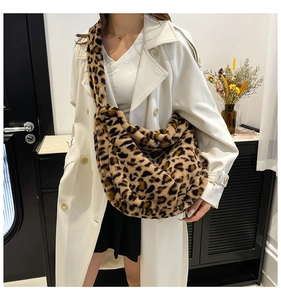 Detail of soft leopard print plush hobo bag with thick faux fur texture and wide strap