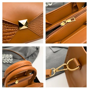 Detailed close-up of brown leather bag showing crocodile pattern and gold hardware details