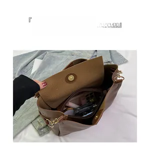 Top view of spacious brown leather tote bag interior with cosmetics and zip compartment