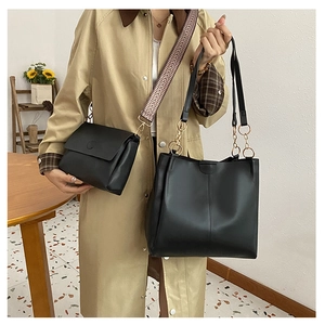 Detail of 2-piece black tote and crossbody bag set with jacquard strap on a model
