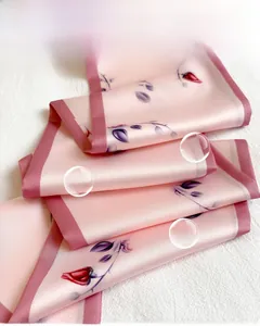 Close-up of silk-feel scarf with floral patterns on textured cotton-linen fabric