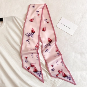 Detail of pink rose pattern skinny silk scarf on white tee with card