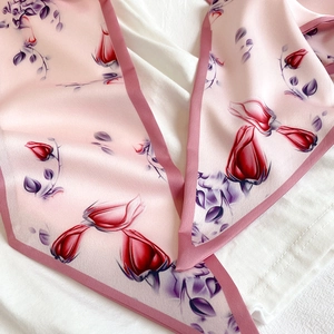 Detail of elegant pink rose pattern on silky long scarf with deep pink contrast edges