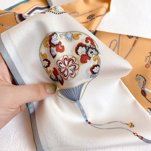 Detail of silk scarf with traditional fan and cloud patterns and fine hem edges