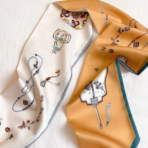 Detail of silk scarf with classic Chinese floral fans and tassels in ivory and orange