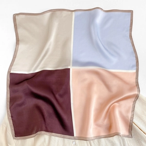 Close-up of color-block mulberry silk scarf with premium satin finish and elegant folds