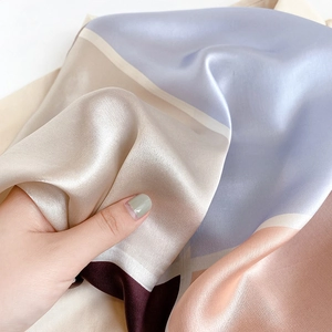 Detailed view of the soft silk scarf texture with purple and champagne color blocks
