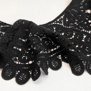 Close-up of intricate black hollow crochet lace detail with elegant floral patterns