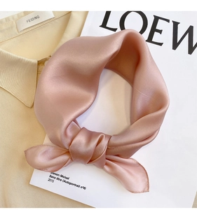 Detailed view of pink silk square scarf with soft satin luster and neat stitched edges