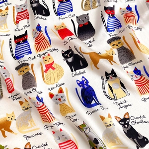 Macro detail of the 100% mulberry silk scarf featuring vibrant cat illustrations and text