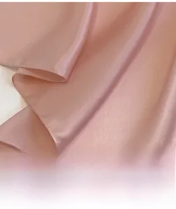 Close-up of pink silk scarf showing premium machine-rolled edges and smooth satin texture