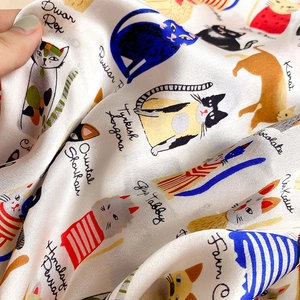 Detailed view of hand-drawn cat illustrations on 100% mulberry silk square scarf fabric