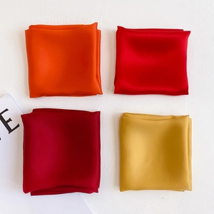 Detailed grid of four satin silk scarves in vibrant orange, red, burgundy and gold