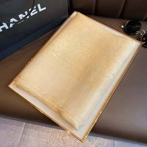 Detailed texture of champagne gold silk blend scarf with metallic lurex woven pattern