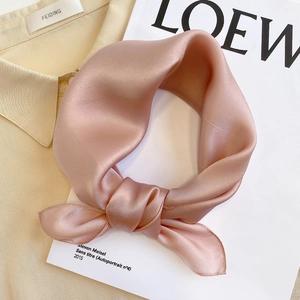 Elegant solid pink silk square scarf with soft satin sheen displayed on a neutral background
