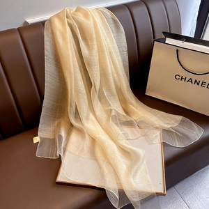 Detail of champagne gold silk shawl with metallic lurex texture and vertical stripes