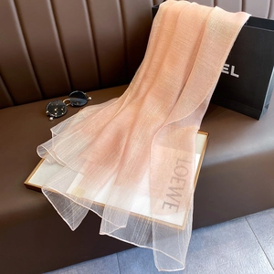 Detail of light pink silk blend scarf featuring subtle gold metallic thread texture