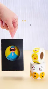Detail of waterproof emoji reward stickers applied on a black packaging box for decoration
