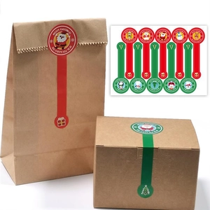 Close-up of long Christmas sealing stickers with Santa and snowman on kraft paper bags