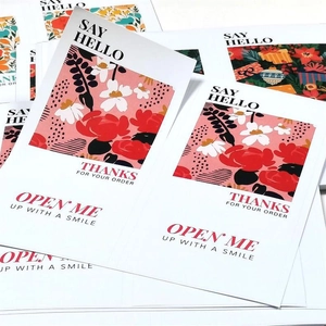 Close-up of floral thank you cards with texts Thanks For Your Order and Open Me Up With A Smile