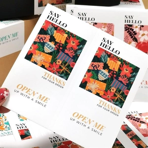 Close-up of rectangular floral thank you stickers for gift box sealing and bakery packaging