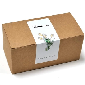 Detail of white rectangle tulip sticker on brown corrugated gift box packaging