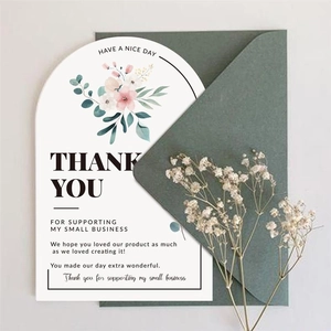 Detail of an arched floral thank you card with watercolor design and green envelope
