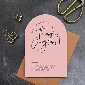 Pink arched thank you card with gold clips on a textured grey background for small business
