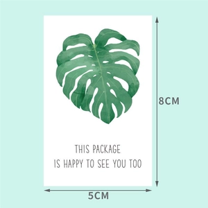 Macro shot of 8x5cm green leaf rectangular packaging sticker with warm greetings