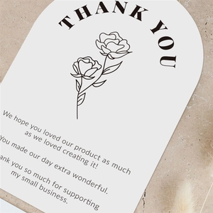 Arched pink floral thank you card on marble surface with soft dried flower decor
