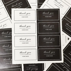 Detail of rectangular black and white stickers with Thank You and Homemade text