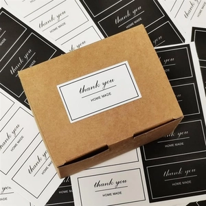 Detail of kraft paper gift box with rectangular thank you and homemade adhesive labels