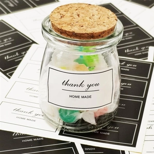 Close-up of thank you homemade label on glass storage jar with a cork lid